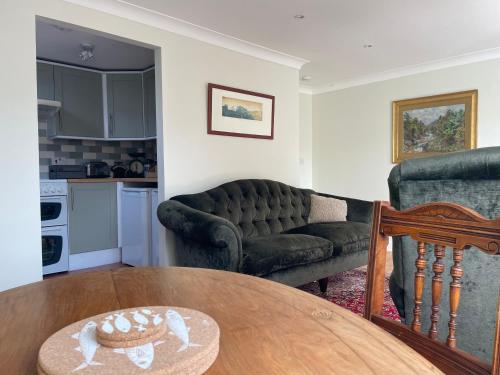a living room with a couch and a table at The Garden House in Bishop Burton
