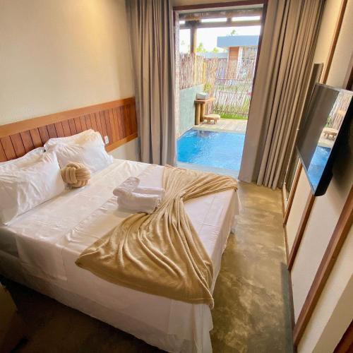 a bedroom with a bed and a swimming pool at Kaha Mar - Patacho in Pôrto de Pedras