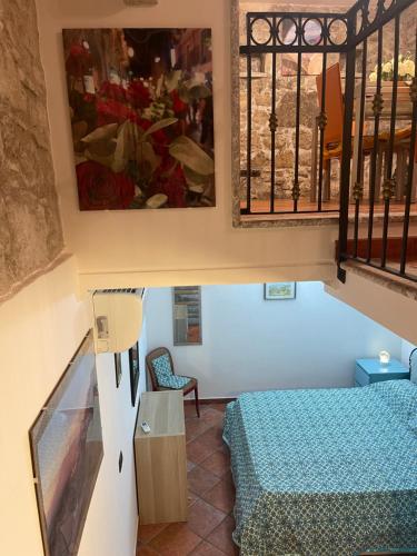 a small room with a bed and a window at Majolica Taormina Apartment in Taormina
