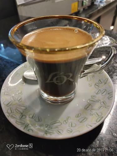 a cup of coffee on a plate on a table at Magníficos Ap Luxo - 43mts e 63mts, 1 ou 2 Qtos in São Paulo