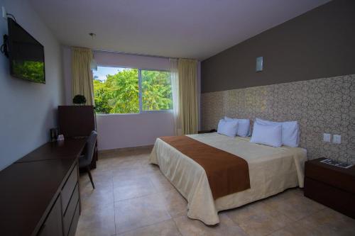 Ένα ή περισσότερα κρεβάτια σε δωμάτιο στο Hotel Verdi