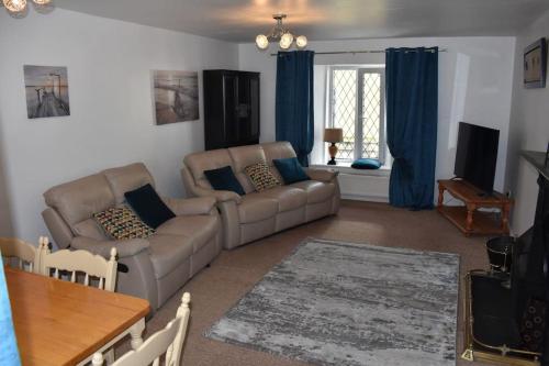 a living room with a couch and a table at Seaside 3 Bed Killybegs Property on Main Street in Killybegs