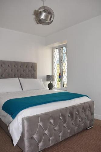 a bedroom with a large bed and a window at Seaside 3 Bed Killybegs Property on Main Street in Killybegs