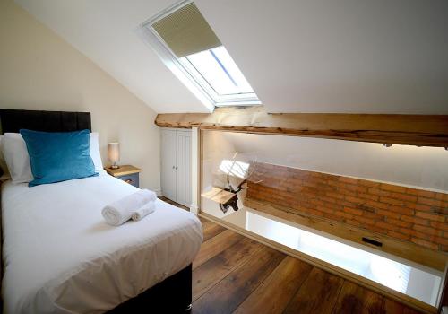 a bedroom with a bed and a brick wall at Pippin Lodge Lytham in Lytham St Annes