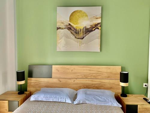 a bedroom with a bed and two lamps and a painting at Athens nice apartment in Athens