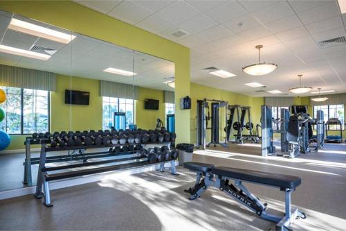a gym with rows of benches and weights at Amazing 6BR Villa @ Storey Lake Resort Near Disney in Kissimmee
