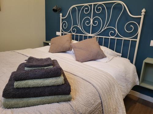 a bed with two blankets and pillows on it at Appartement - B&B 'la bienvenue' in Venlo, Limburg in Venlo