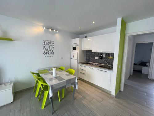 a kitchen and dining room with a table and chairs at New Pistachio Apartment in Costa Teguise