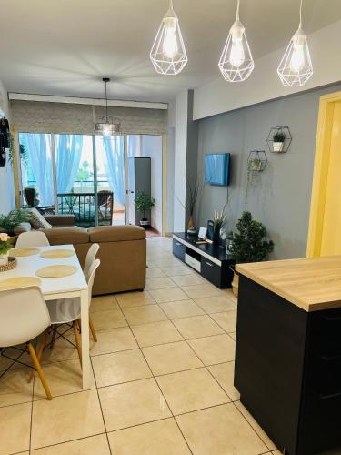 a living room with a couch and a table at Carisa Holiday rooms in Larnaca