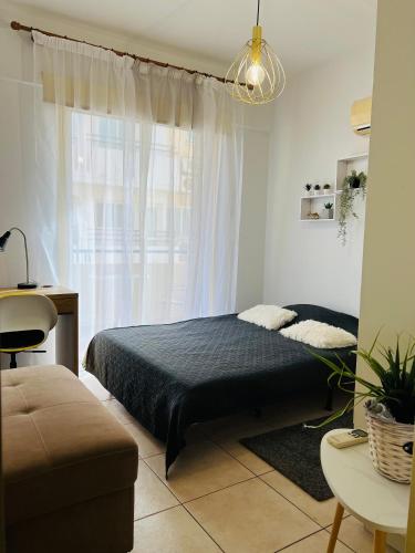 a bedroom with a bed and a window at Carisa Holiday rooms in Larnaca
