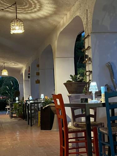 a restaurant with tables and chairs and a ceiling at Villa Anna GuestHouse in Brindisi