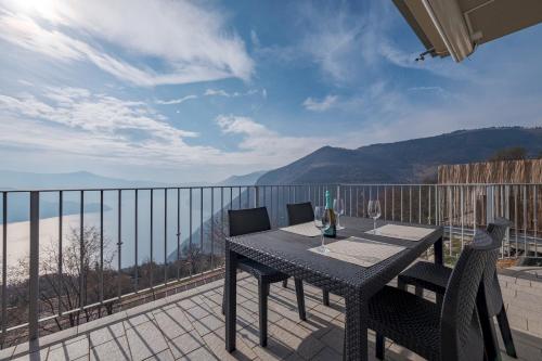 a table and chairs on a balcony with a view at Donatello in Parzanica