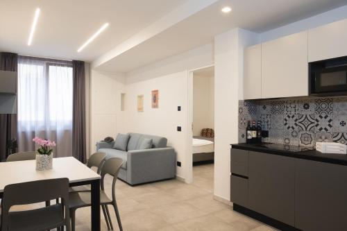 a kitchen and living room with a table and a couch at Amiata Suite in Abbadia San Salvatore