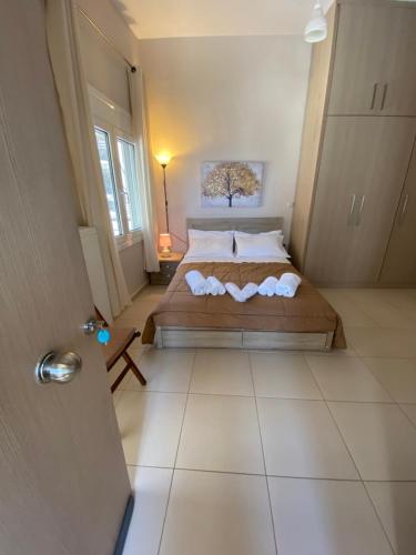 a bedroom with a large bed in a room at BLUE PHAISTOS APARTMENTS No1 in Moírai