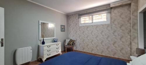 a bedroom with a blue bed and a window at Apartamento A Guarda in A Guarda