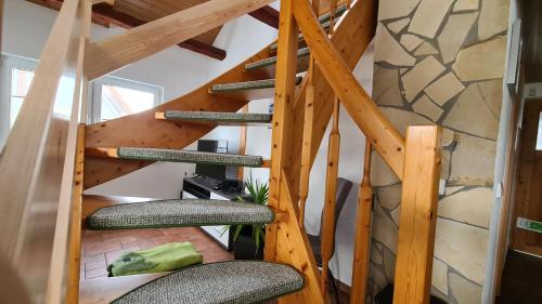 a wooden spiral staircase in a house with chairs at Ferienhaus Marx in Sebnitz