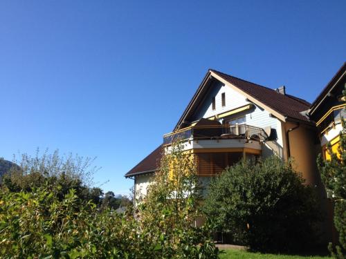 a white house with a brown roof at Apart Holidays in Morschach