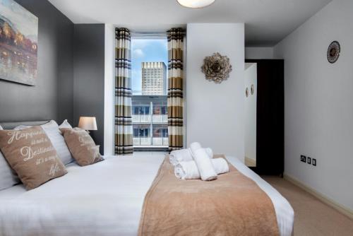 a bedroom with a large bed and a large window at Birmingham Skyline Apartment Bullring Central Walking Distance in Birmingham
