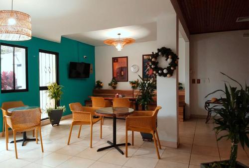 a dining room with a table and chairs at Trebol Amarillo Bed & Breakfast in Escazu