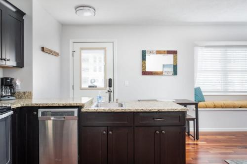 a kitchen with a sink and a counter top at Midtown Condo 9 Great Traverse City Location in Traverse City
