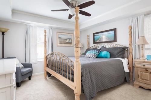 a bedroom with a bed and a ceiling fan at Midtown Condo 9 Great Traverse City Location in Traverse City