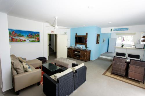a living room with a couch and a tv at Westpunt Beach Apartments in Willemstad