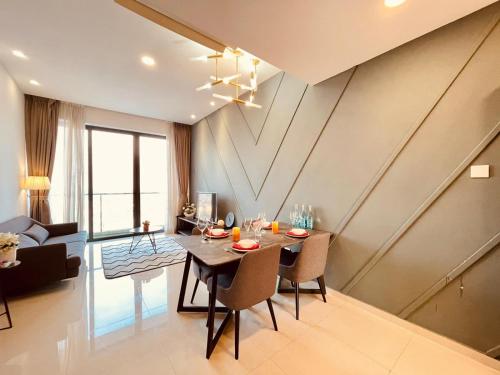 a dining room and living room with a table and chairs at SRT Suites - The Skyline in Phnom Penh