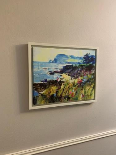 a painting hanging on a wall on a wall at Boland's Accommodation Dingle in Dingle