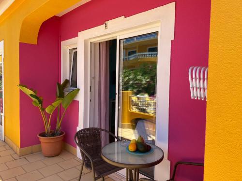 a colorful house with a table and chairs at Vila Graciosa - Tranquility Oasis in Lagos