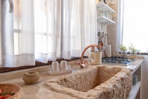 a kitchen counter with a sink in a kitchen at Il Chioschetto in Francavilla Fontana