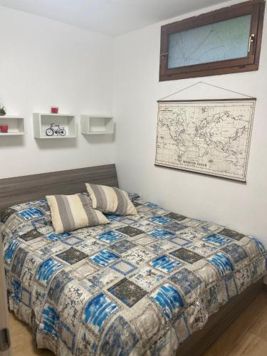 a bedroom with a bed with a map on the wall at Stella Marina in Fertilia