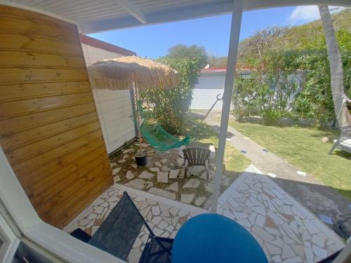 a view of a patio from the inside of a house at La Rose du Bresil Marie-Galante in Capesterre-de-Marie-Galante