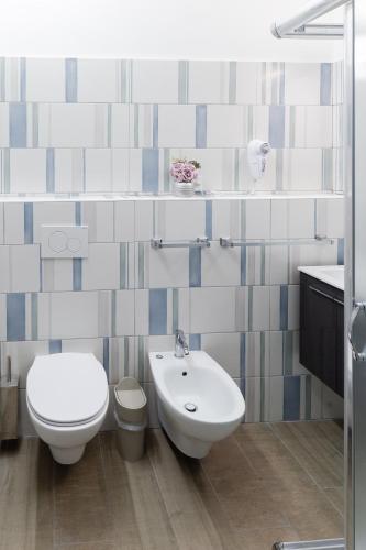 a bathroom with a toilet and a bidet and a sink at Affittacamere Alessia in Sanremo