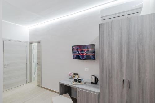 a white room with a desk and a sliding door at Affittacamere Alessia in Sanremo
