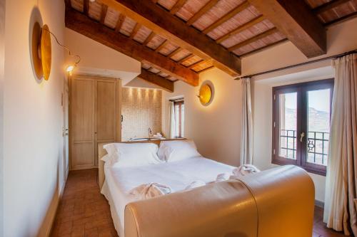 Postel nebo postele na pokoji v ubytování Oste del Castello Wellness & Bike Hotel