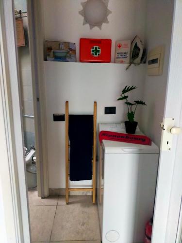 a small kitchen with a sink and a washing machine at THE ROOFTOP in Pero