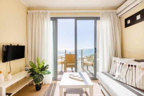 a living room with a couch and a view of the ocean at Vista Mare Beach Apartments by Porto City Hosts in Cortegaça