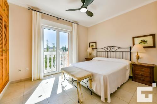 a bedroom with a bed and a large window at Villa Angeles - Grupo Turis in Calpe