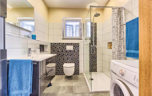 a bathroom with a sink and a washing machine at Stunning Apartment In Jesenice With 4 Bedrooms, Wifi And Outdoor Swimming Pool in Jesenice