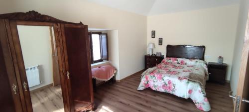 a bedroom with a bed and a dresser at Casa Ángel in Barreiros