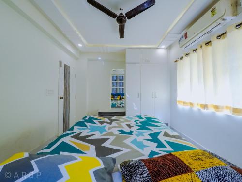 a bedroom with a bed and a ceiling fan at Moroccan Suite Calangute Beach Vibe in Calangute