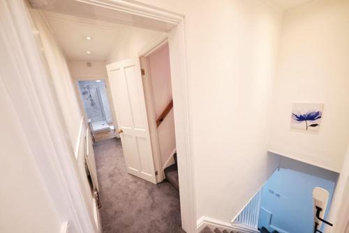 an empty hallway with a staircase in a house at Aspen, 3 Bedrooms with Parking in Birmingham