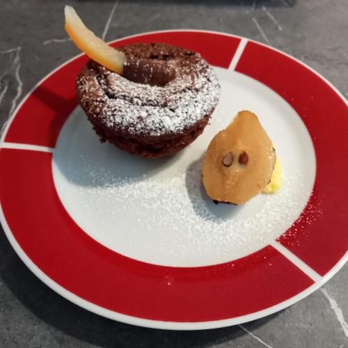 a red and white plate with a chocolate donut and a cookie at SANTINO'S HOUSE in Peveragno