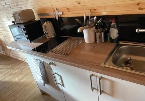a kitchen with a sink and a counter top at Fox's Den in Bathgate