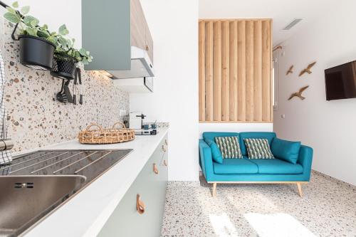 a kitchen with a blue couch and a sink at La Maison Du Pêcheur in Cagnes-sur-Mer