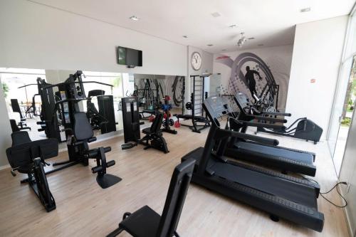 a gym with treadmills and ellipticals in a room at H2 Platinum Lourdes in Belo Horizonte