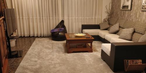 a living room with a couch and a coffee table at Casa Barranqueiro in Vilaboa
