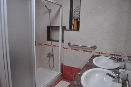 a bathroom with two sinks and a shower at Casa Barranqueiro in Vilaboa