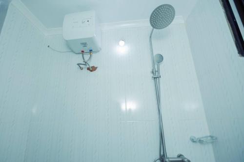 a bathroom with a shower with a shower head and a shower at Stunning 2-Bed Apartment in Moshi Town in Moshi