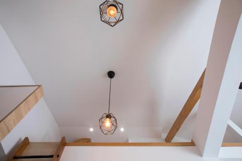 a staircase in a house with a chandelier at Pano Kopaonik Panorama in Kopaonik